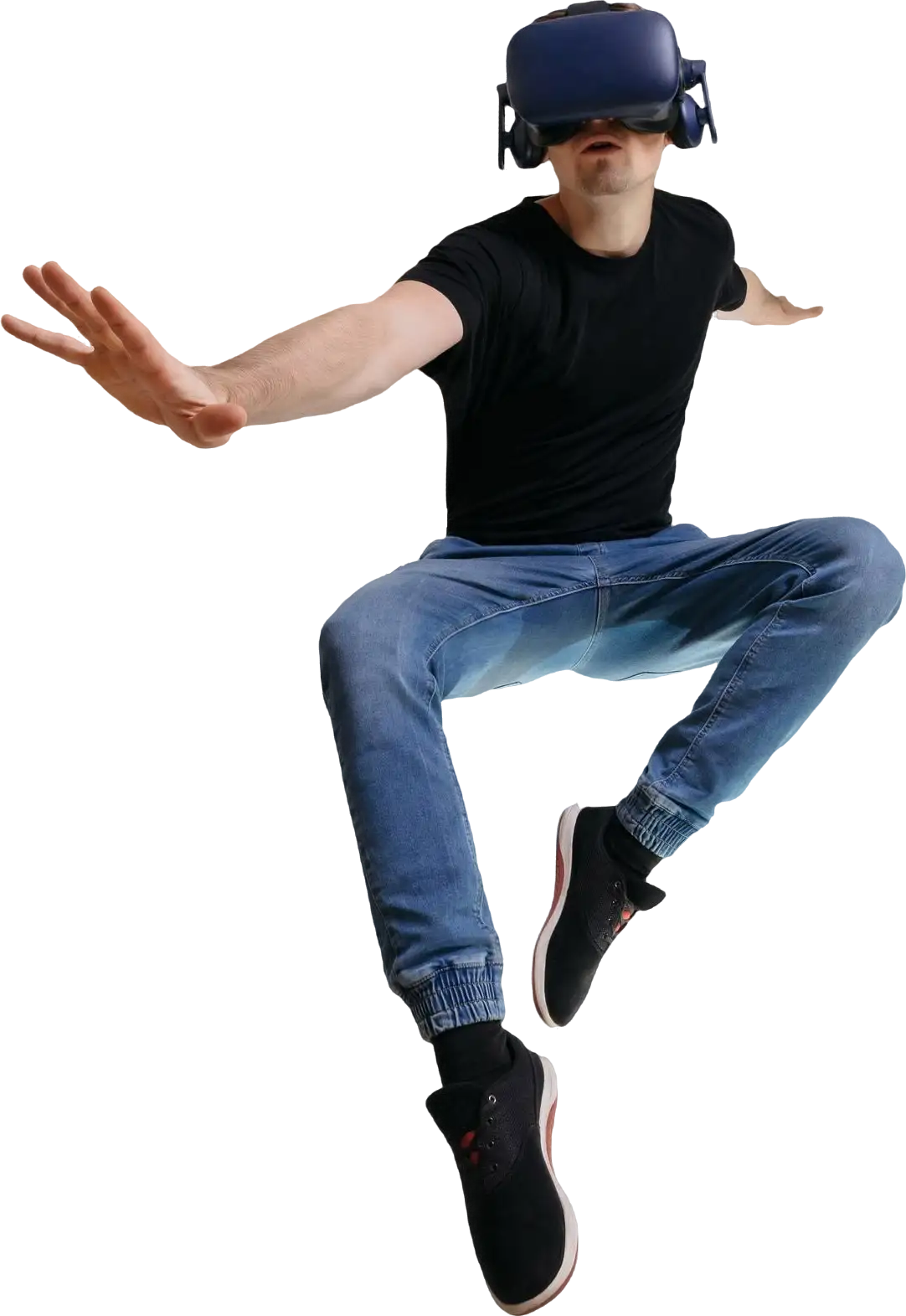 Caucasian male, approximately 25 years old, with short dark hair, wearing a black t-shirt and blue jeans, in a dynamic pose appearing to jump or balance with one arm extended and the other bent, set against a plain white background, designed by Evovise for immersive digital experiences