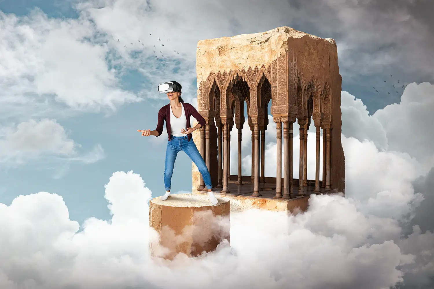 Young adult male with light skin and short dark hair, wearing a virtual reality headset and casual clothing, standing on a floating platform surrounded by clouds, interacting with a virtual environment, with a partially ruined architectural structure featuring intricate arches behind him, set against a blue sky with scattered clouds, designed by Evovise for immersive digital experiences